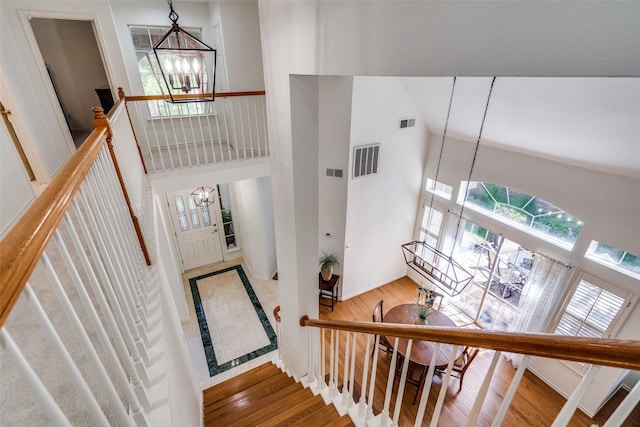 1908 Vantage Dr, Plano, TX 75075 - stairway featuring a chandelier, a high ceiling, and wood finished floors