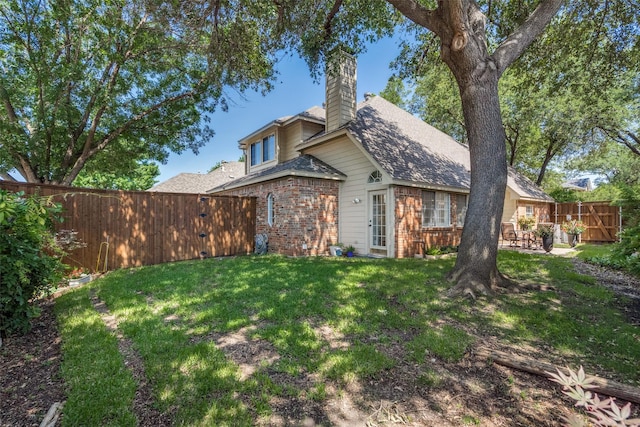 1908 Vantage Dr, Plano, TX 75075 - rear view of house with brick siding, a chimney, and a fenced backyard