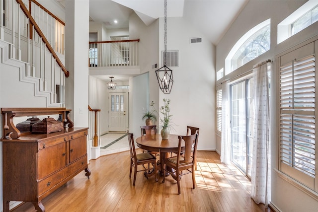 1908 Vantage Dr, Plano, TX 75075 - dining room featuring high vaulted ceiling, light wood-style floors, and stairs