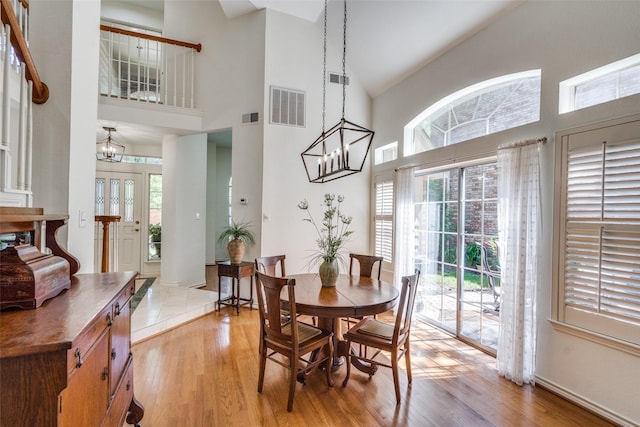 1908 Vantage Dr, Plano, TX 75075 - dining space featuring high vaulted ceiling, a chandelier, and light wood-type flooring