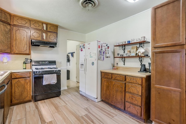 2805 Sadler Ave, Fort Worth, TX 76133 - kitchen featuring gas range oven, white fridge with ice dispenser, under cabinet range hood, brown cabinetry, and light countertops