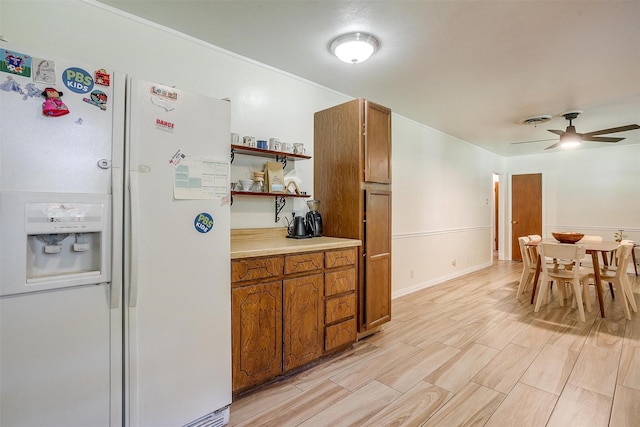 2805 Sadler Ave, Fort Worth, TX 76133 - kitchen with white refrigerator with ice dispenser, brown cabinets, open shelves, ceiling fan, and light countertops
