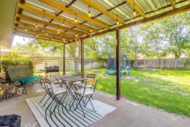 2805 Sadler Ave, Fort Worth, TX 76133 - fenced backyard with a trampoline, a patio, and outdoor dining space