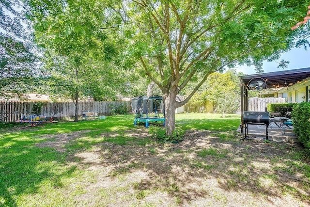 2805 Sadler Ave, Fort Worth, TX 76133 - fenced backyard featuring a trampoline