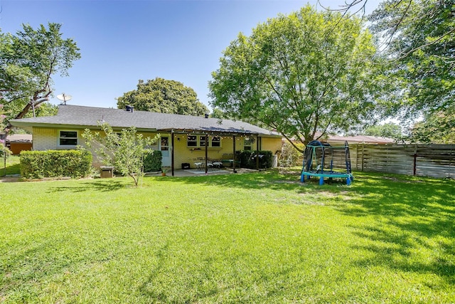 2805 Sadler Ave, Fort Worth, TX 76133 - back of house featuring a trampoline, a patio, and brick siding