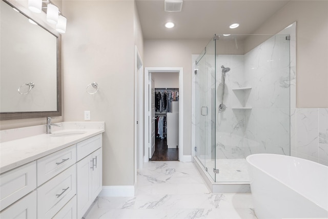 8538 Church St, Frisco, TX 75034 - bathroom with a marble finish shower, vanity, marble finish flooring, a soaking tub, and a spacious closet