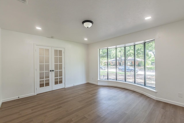 1517 Amherst Dr, Plano, TX 75075 - unfurnished room with french doors, wood finished floors, and recessed lighting