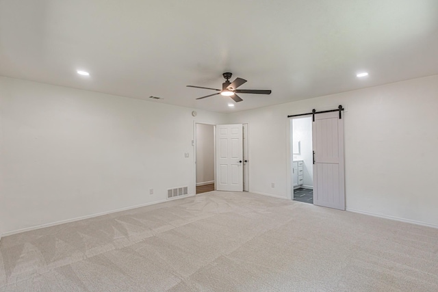 1517 Amherst Dr, Plano, TX 75075 - unfurnished bedroom with a barn door, recessed lighting, carpet flooring, ensuite bathroom, and a ceiling fan