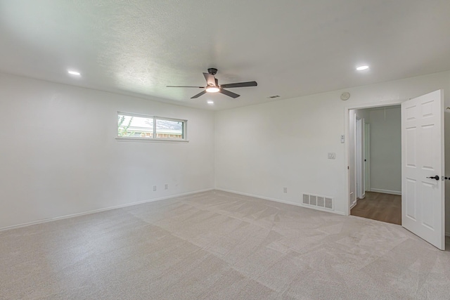1517 Amherst Dr, Plano, TX 75075 - spare room featuring ceiling fan, light colored carpet, and recessed lighting