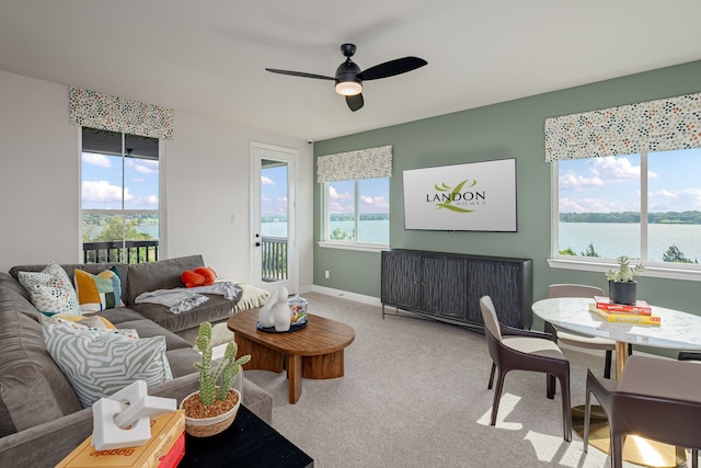 2718 Sunrise Dr, Rowlett, TX 75089 - living room with healthy amount of natural light, light colored carpet, ceiling fan, and a water view