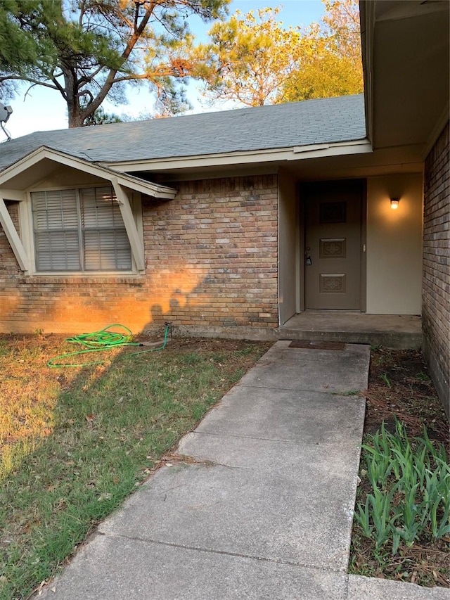 5410 Kings Manor Dr, Lake Dallas, TX 75065 - doorway to property featuring brick siding and roof with shingles
