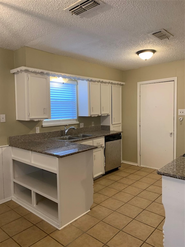 5410 Kings Manor Dr, Lake Dallas, TX 75065 - kitchen with stainless steel dishwasher, white cabinets, light tile patterned floors, a textured ceiling, and open shelves