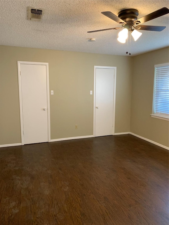 5410 Kings Manor Dr, Lake Dallas, TX 75065 - unfurnished room with dark wood-style floors, a ceiling fan, and a textured ceiling
