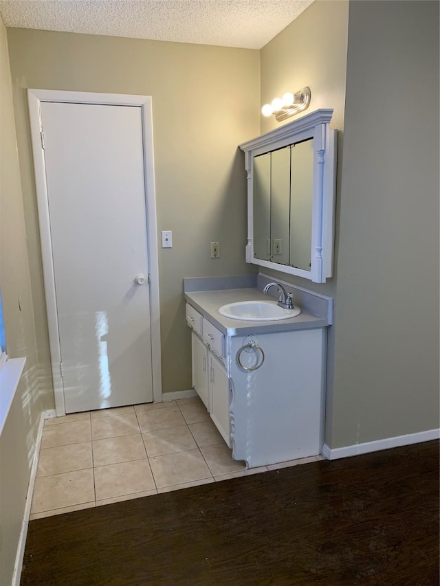 5410 Kings Manor Dr, Lake Dallas, TX 75065 - bathroom featuring vanity, tile patterned flooring, and a textured ceiling