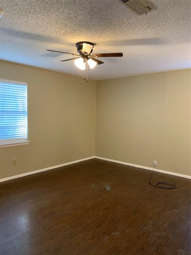 5410 Kings Manor Dr, Lake Dallas, TX 75065 - unfurnished room with a ceiling fan, dark wood-style flooring, and a textured ceiling