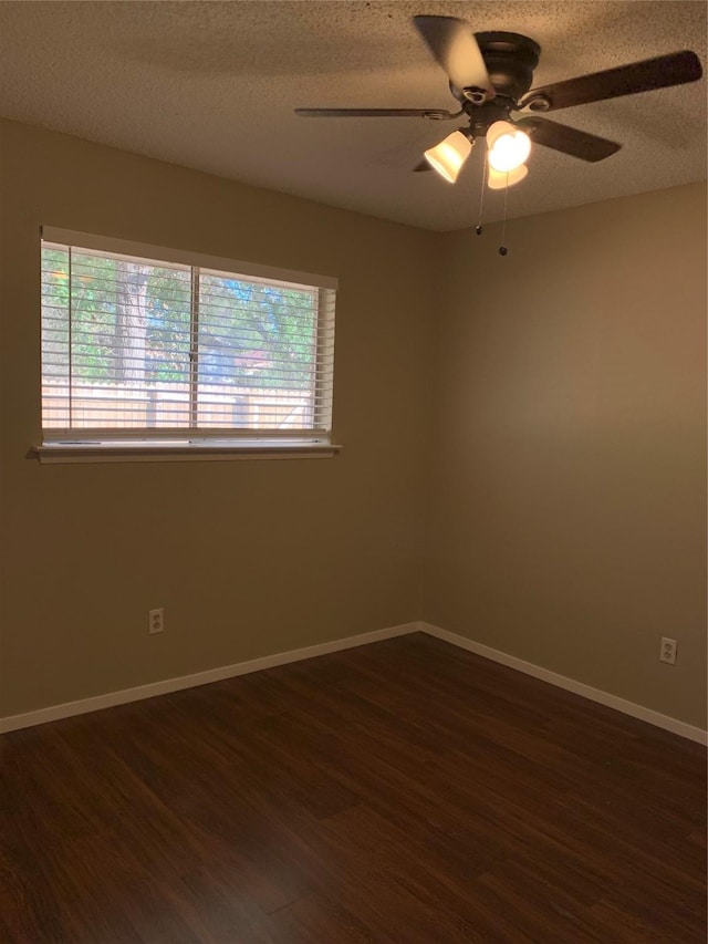 5410 Kings Manor Dr, Lake Dallas, TX 75065 - spare room featuring dark wood-style flooring, a textured ceiling, and ceiling fan