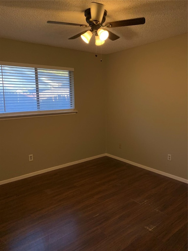 5410 Kings Manor Dr, Lake Dallas, TX 75065 - empty room featuring dark wood-style floors, ceiling fan, and a textured ceiling
