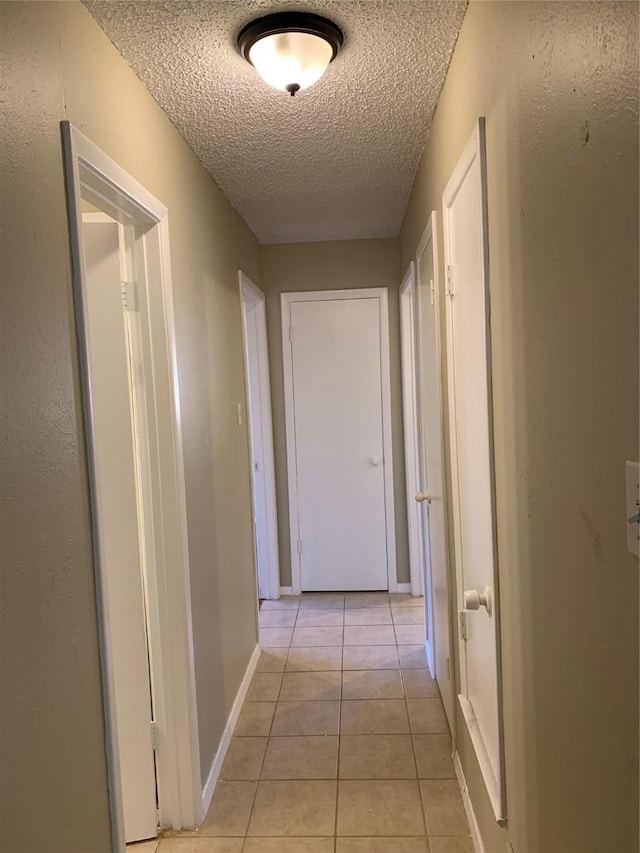 5410 Kings Manor Dr, Lake Dallas, TX 75065 - corridor with a textured ceiling and light tile patterned flooring