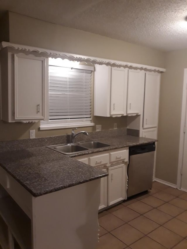 5410 Kings Manor Dr, Lake Dallas, TX 75065 - kitchen with dishwasher, white cabinets, a textured ceiling, light tile patterned flooring, and a peninsula