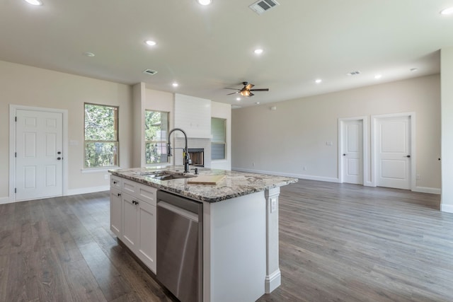 458 Jim Walters Dr, Runaway Bay, TX 76426 - kitchen with stainless steel dishwasher, ceiling fan, white cabinetry, wood finished floors, and a brick fireplace