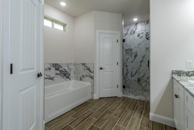 458 Jim Walters Dr, Runaway Bay, TX 76426 - full bath featuring a garden tub, vanity, a marble finish shower, wood tiled floors, and recessed lighting
