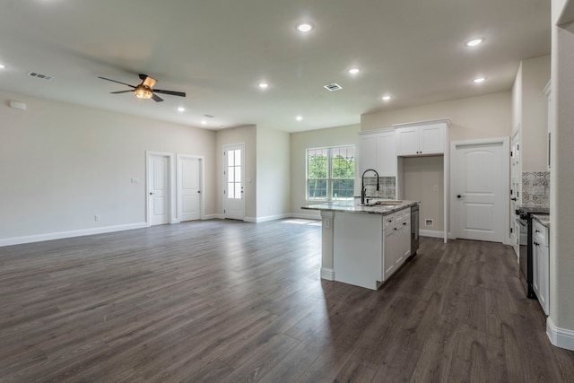 458 Jim Walters Dr, Runaway Bay, TX 76426 - kitchen with open floor plan, a ceiling fan, white cabinets, light stone countertops, and a kitchen island with sink
