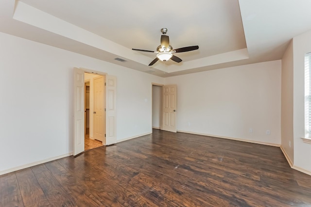 2230 Bridle Path Dr, Lancaster, TX 75146 - empty room featuring a tray ceiling, wood finished floors, and a ceiling fan