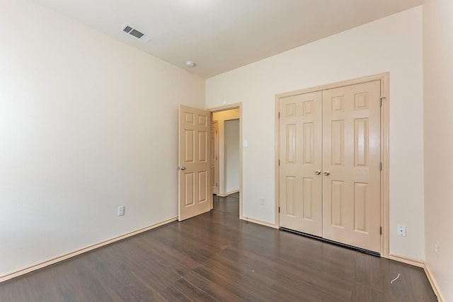 2230 Bridle Path Dr, Lancaster, TX 75146 - unfurnished bedroom featuring dark wood-style flooring and a closet