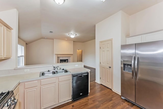 2230 Bridle Path Dr, Lancaster, TX 75146 - kitchen with stainless steel appliances, a peninsula, dark wood-type flooring, light countertops, and lofted ceiling