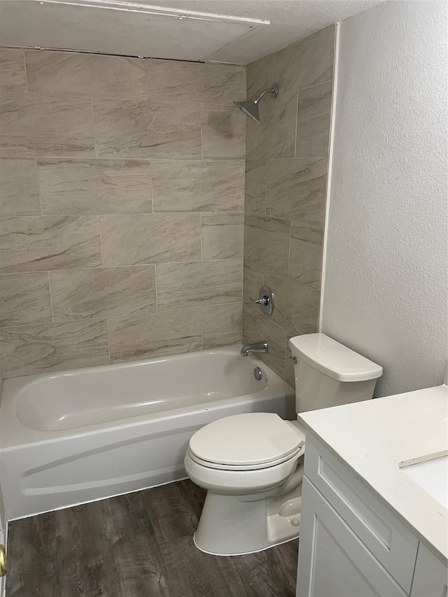 3954 Cambridge, Garland, TX 75043 - bathroom featuring vanity, wood finished floors, shower / tub combination, and a textured wall