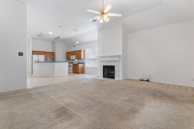 6716 Armstrong Ct, Fort Worth, TX 76137 - unfurnished living room with light carpet, vaulted ceiling, a tile fireplace, ceiling fan, and light tile patterned floors