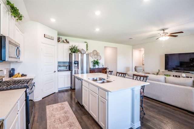 595 Yucca Ct, Princeton, TX 75407 - kitchen featuring stainless steel appliances, open floor plan, a kitchen bar, dark wood finished floors, and recessed lighting