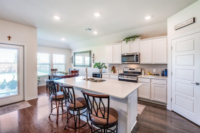 595 Yucca Ct, Princeton, TX 75407 - kitchen with stainless steel appliances, a kitchen island with sink, dark wood finished floors, backsplash, and recessed lighting