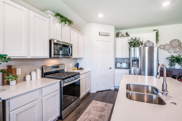595 Yucca Ct, Princeton, TX 75407 - kitchen with appliances with stainless steel finishes, light countertops, white cabinetry, decorative backsplash, and dark wood finished floors