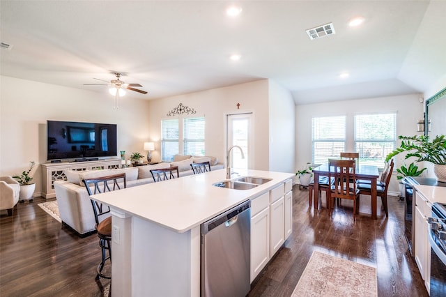 595 Yucca Ct, Princeton, TX 75407 - kitchen with stainless steel appliances, a breakfast bar, an island with sink, light countertops, and white cabinetry