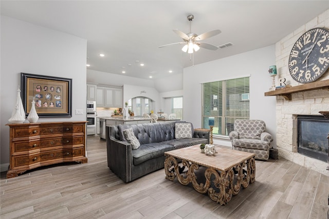 324 Roscoe Dr, Fate, TX 75087 - living room with light wood-type flooring, ceiling fan, a stone fireplace, and recessed lighting