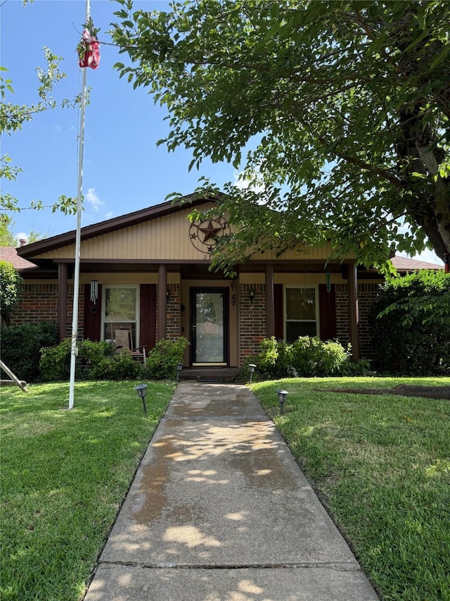 2312 Warm Springs Rd, Mesquite, TX 75149 - single story home featuring a front yard, brick siding, and covered porch
