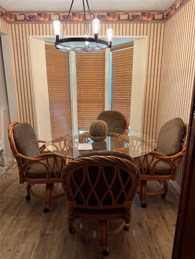 2312 Warm Springs Rd, Mesquite, TX 75149 - dining room with wallpapered walls, hardwood / wood-style flooring, and a textured ceiling