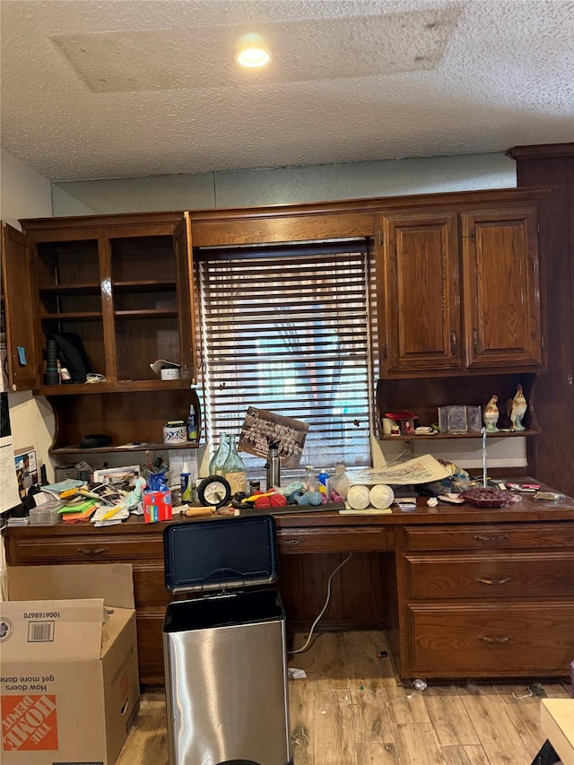 2312 Warm Springs Rd, Mesquite, TX 75149 - home office featuring built in study area, a textured ceiling, and light wood-style flooring