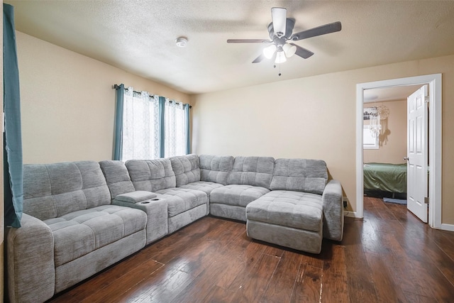 3624 Hardeman St, Fort Worth, TX 76119 - living area featuring dark wood-style flooring, ceiling fan, and a textured ceiling