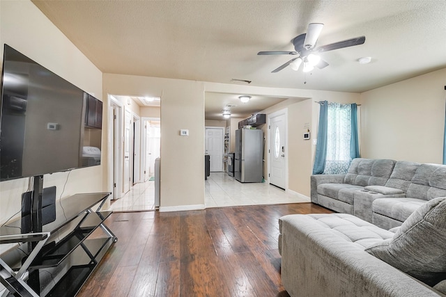 3624 Hardeman St, Fort Worth, TX 76119 - living area with a ceiling fan, light wood-style floors, and a textured ceiling