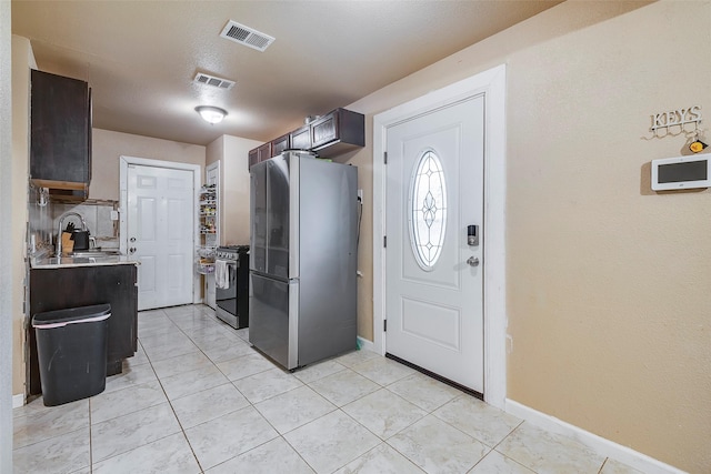 3624 Hardeman St, Fort Worth, TX 76119 - kitchen with appliances with stainless steel finishes, light countertops, and light tile patterned floors
