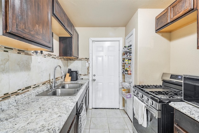 3624 Hardeman St, Fort Worth, TX 76119 - kitchen featuring stainless steel appliances, decorative backsplash, light tile patterned floors, dark brown cabinetry, and light stone countertops
