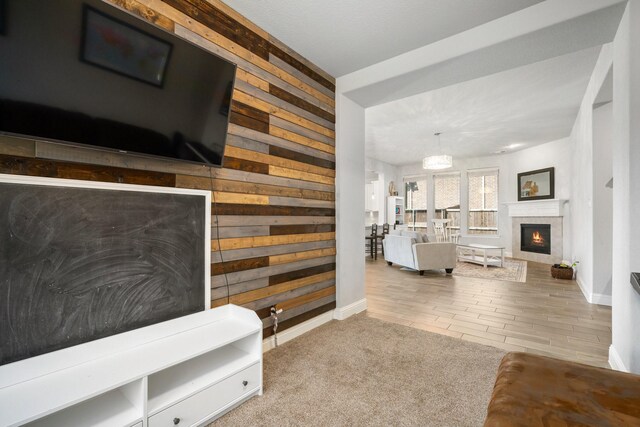 705 Rio Concho Trl, Mckinney, TX 75071 - living room with wooden walls and a lit fireplace