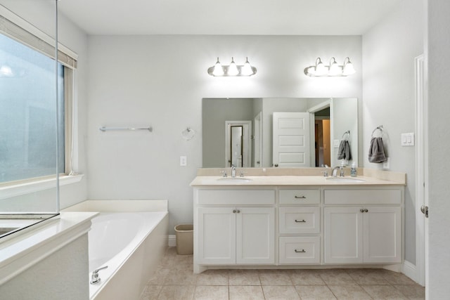 705 Rio Concho Trl, Mckinney, TX 75071 - full bathroom featuring double vanity, a bath, and tile patterned flooring