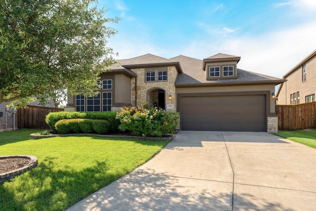 705 Rio Concho Trl, Mckinney, TX 75071 - view of front of property featuring stone siding, concrete driveway, an attached garage, and stucco siding