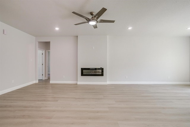 507 S 4th St, Grandview, TX 76050 - unfurnished living room featuring heating unit, a ceiling fan, light wood-type flooring, recessed lighting, and a glass covered fireplace