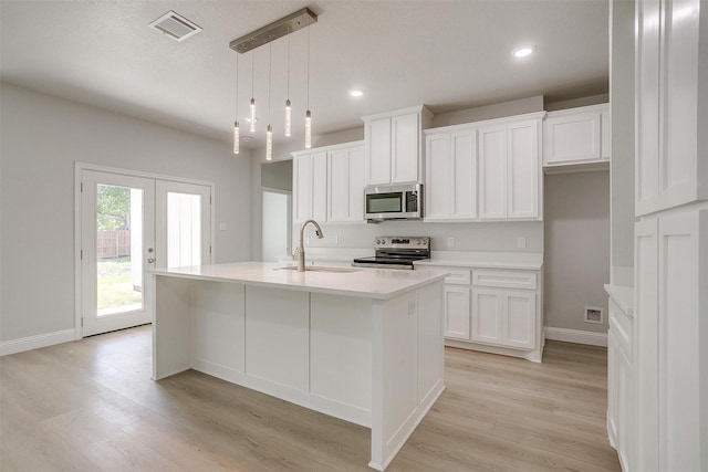 507 S 4th St, Grandview, TX 76050 - kitchen with appliances with stainless steel finishes, white cabinets, light wood-type flooring, and recessed lighting