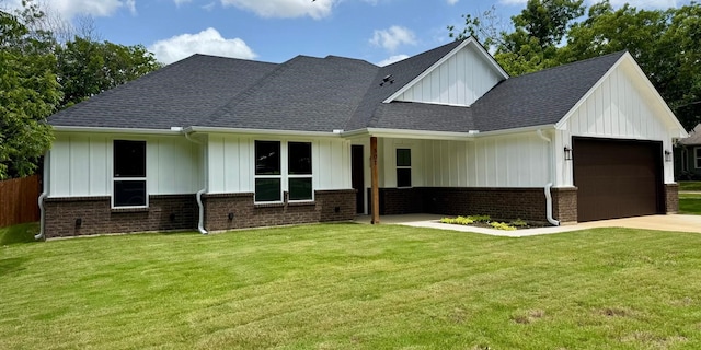 507 S 4th St, Grandview, TX 76050 - view of front of house featuring a garage, board and batten siding, driveway, and a front lawn