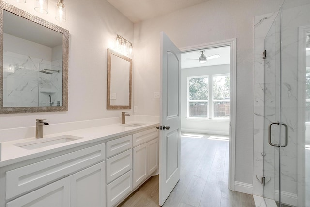 507 S 4th St, Grandview, TX 76050 - bathroom with a marble finish shower, double vanity, and wood finished floors